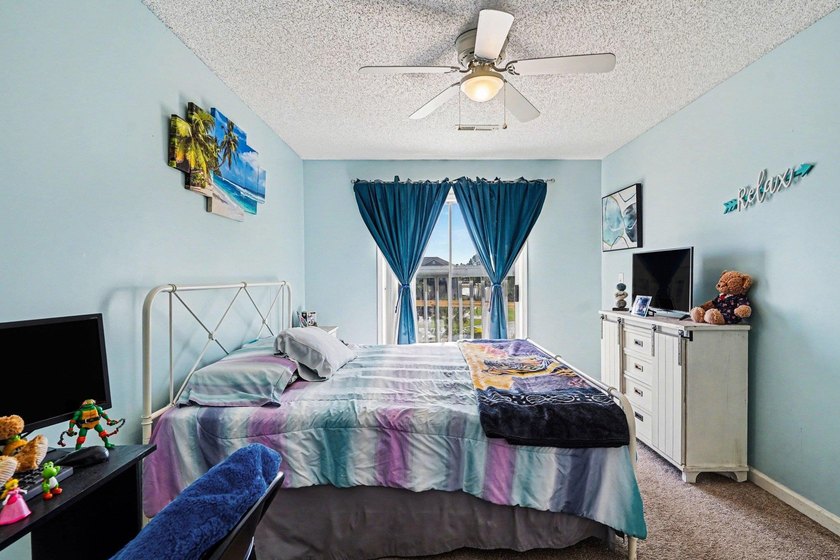 This 3-bedroom, 2-bathroom condo features a bright living room - photo 11