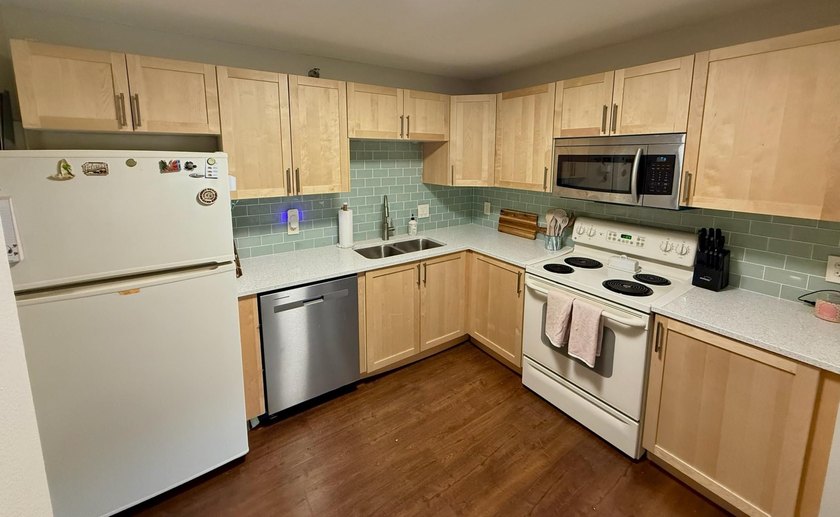 This bright and generously sized corner unit offers an open - photo 3