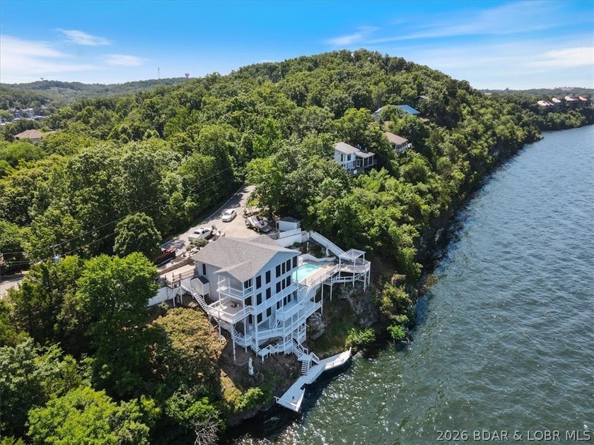 Perched above the shimmering waters of the Lake of the Ozarks - photo 2