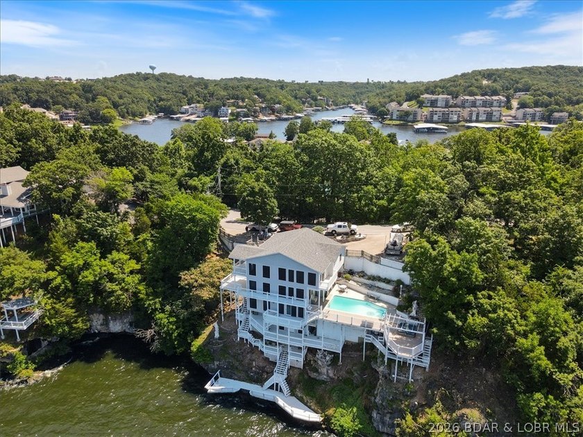 Perched above the shimmering waters of the Lake of the Ozarks - photo 3