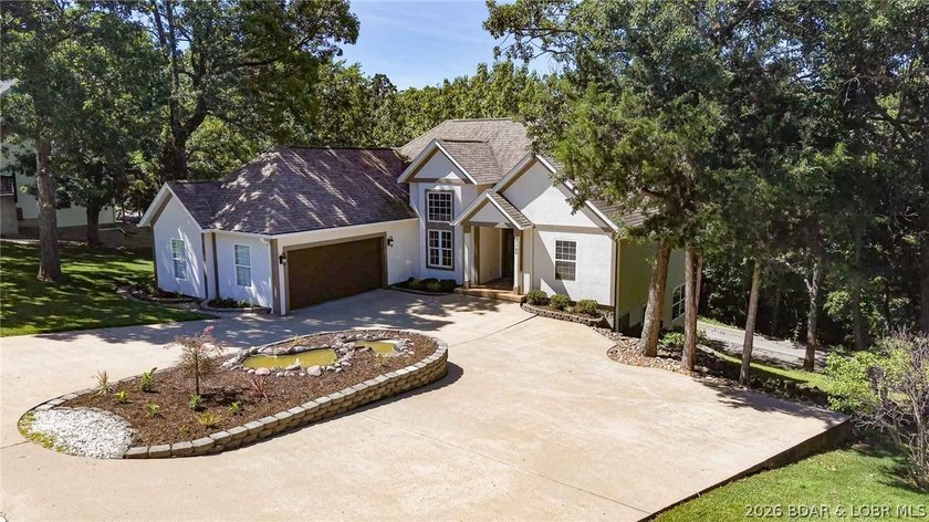 Located on a quiet cul-de-sac w/seasonal lake view in the highly - photo 2