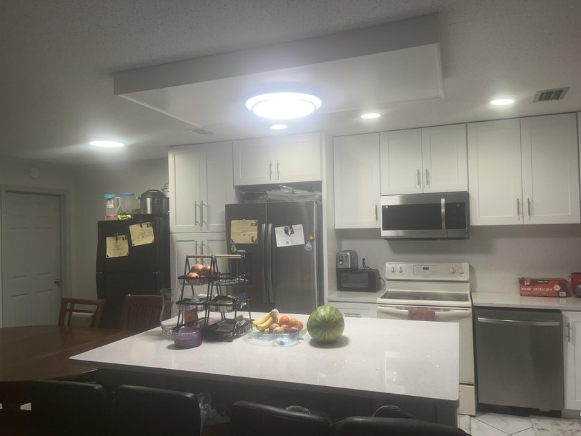 Beautiful home featuring a modern kitchen with white cabinets - photo 13