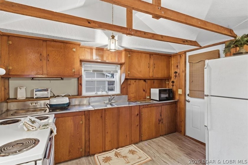 Discover this unique 2-bedroom, 1-bath lakefront cabin offering - photo 9