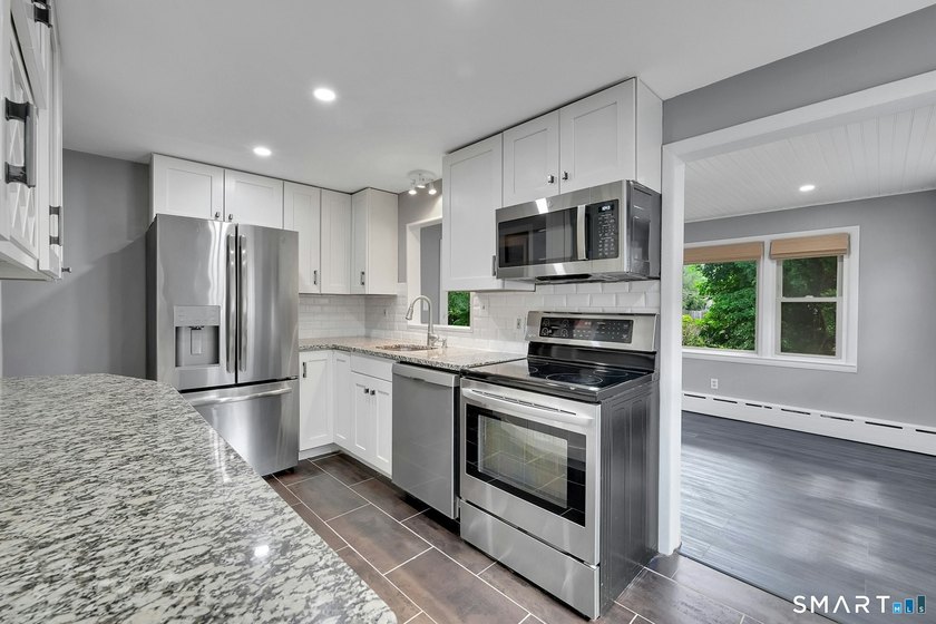 Beautifully updated and deceptively spacious, this move-in ready - photo 8