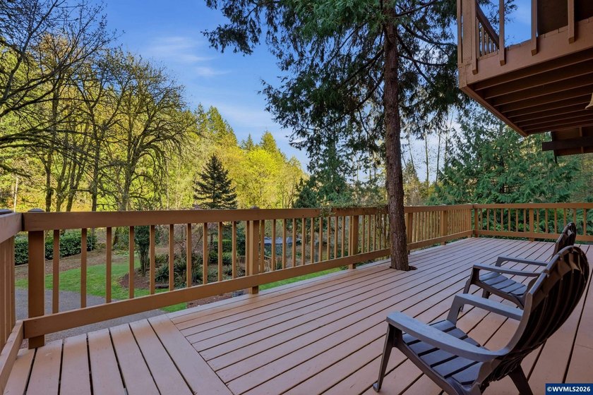 A custom chalet-style home surrounded by natural forest on - photo 14