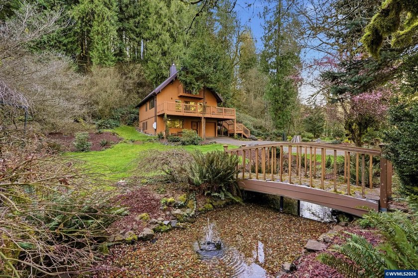 A custom chalet-style home surrounded by natural forest on - photo 15