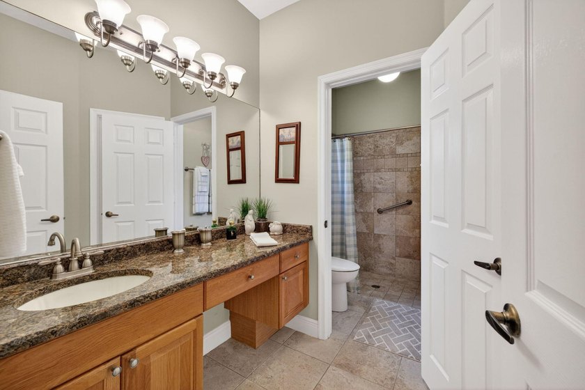 Situated on a large corner lot with lush tropical landscaping - photo 29