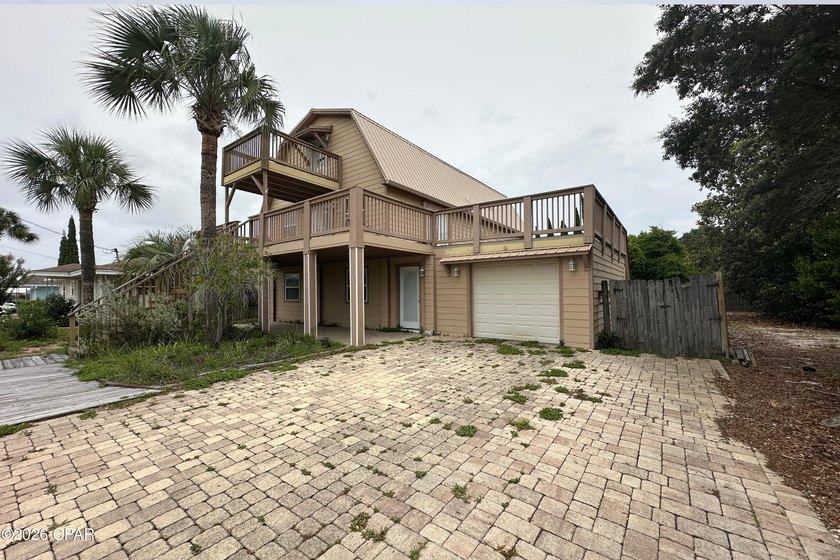 This three-story elevated beach house features 4 bedrooms, 3 - photo 3