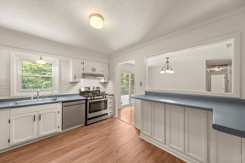 Tucked away on a beautifully wooded and private lot, this - photo 11