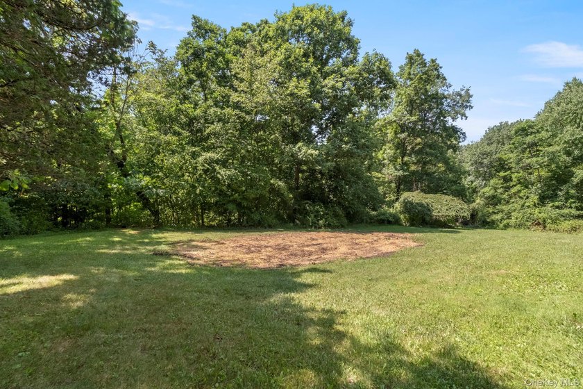 Tucked away on a beautifully wooded and private lot, this - photo 42