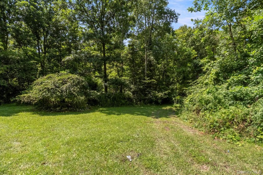 Tucked away on a beautifully wooded and private lot, this - photo 43