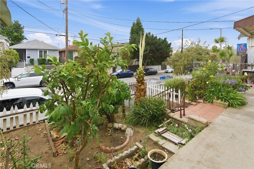 This well-cared for triplex is perched above the street and is - photo 4