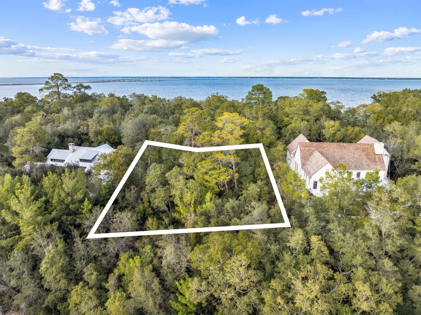 This exceptional 0.33-acre homesite offers bay views within the - photo 2