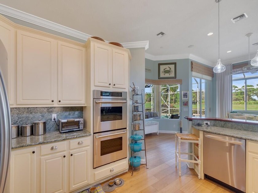 This pool home features a 2022 roof, laminate flooring - photo 11