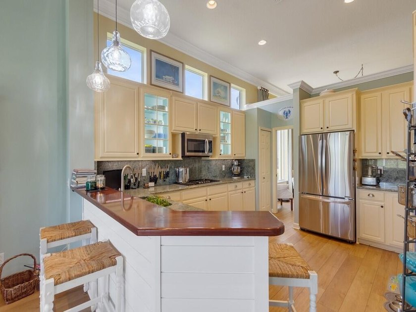This pool home features a 2022 roof, laminate flooring - photo 12