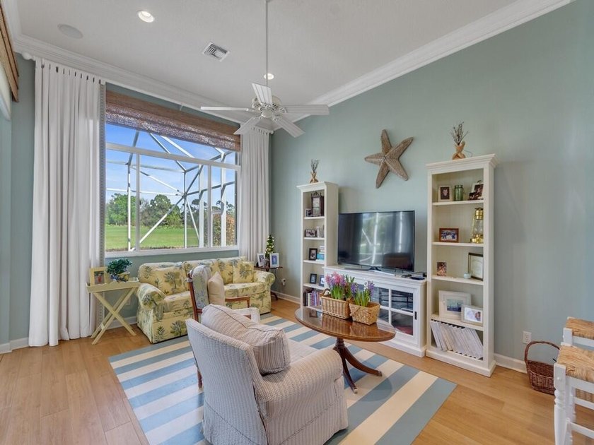 This pool home features a 2022 roof, laminate flooring - photo 13
