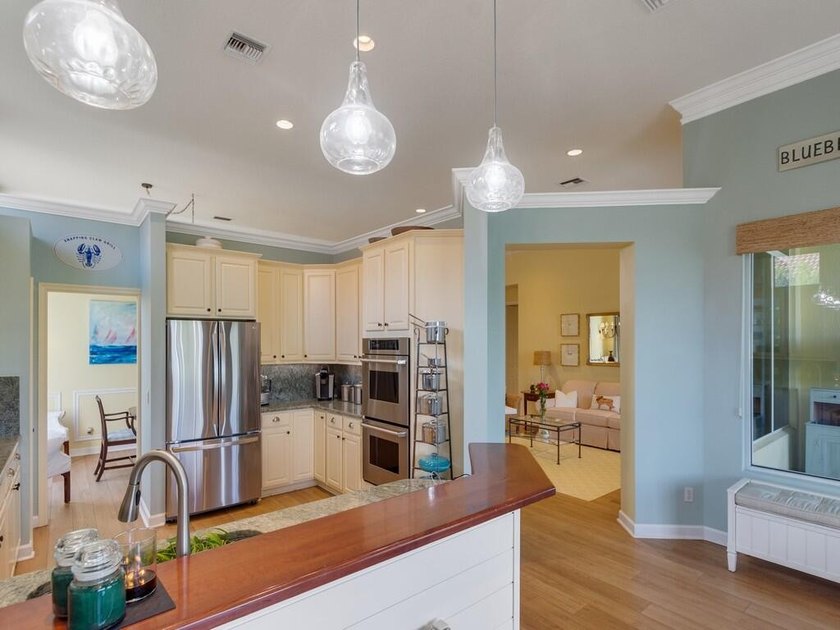 This pool home features a 2022 roof, laminate flooring - photo 15