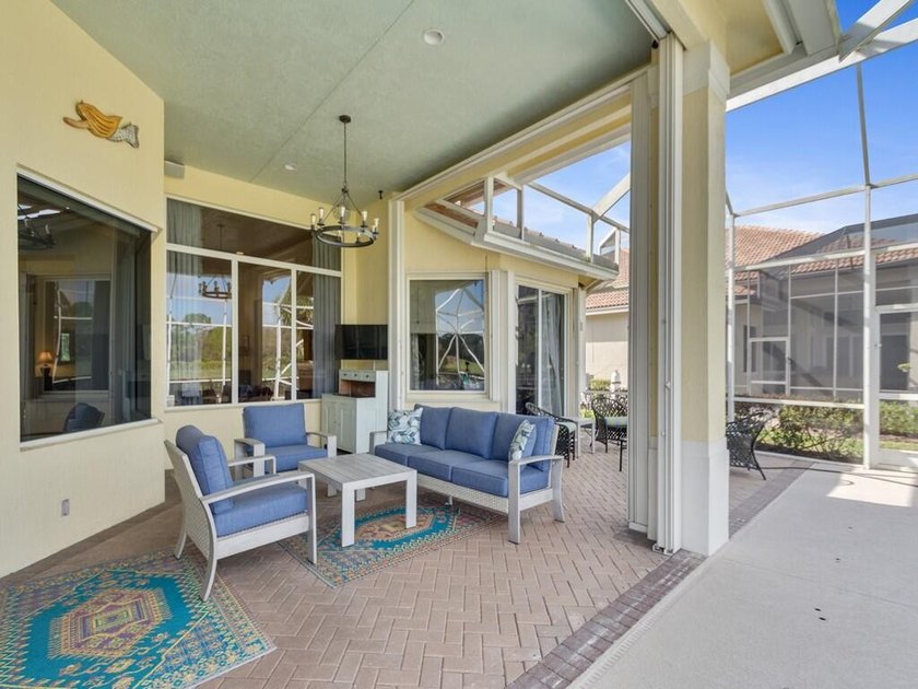 This pool home features a 2022 roof, laminate flooring - photo 16