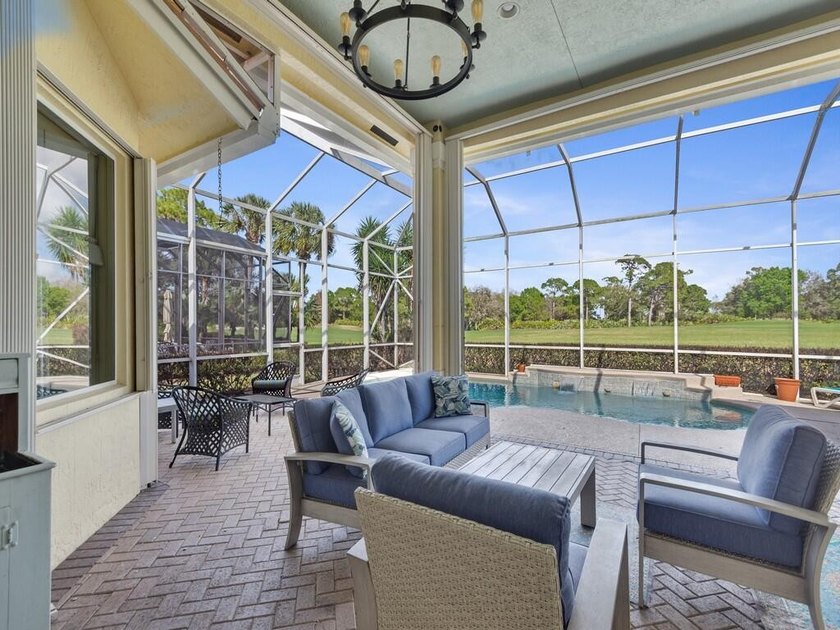 This pool home features a 2022 roof, laminate flooring - photo 17