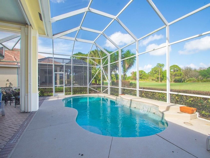 This pool home features a 2022 roof, laminate flooring - photo 18