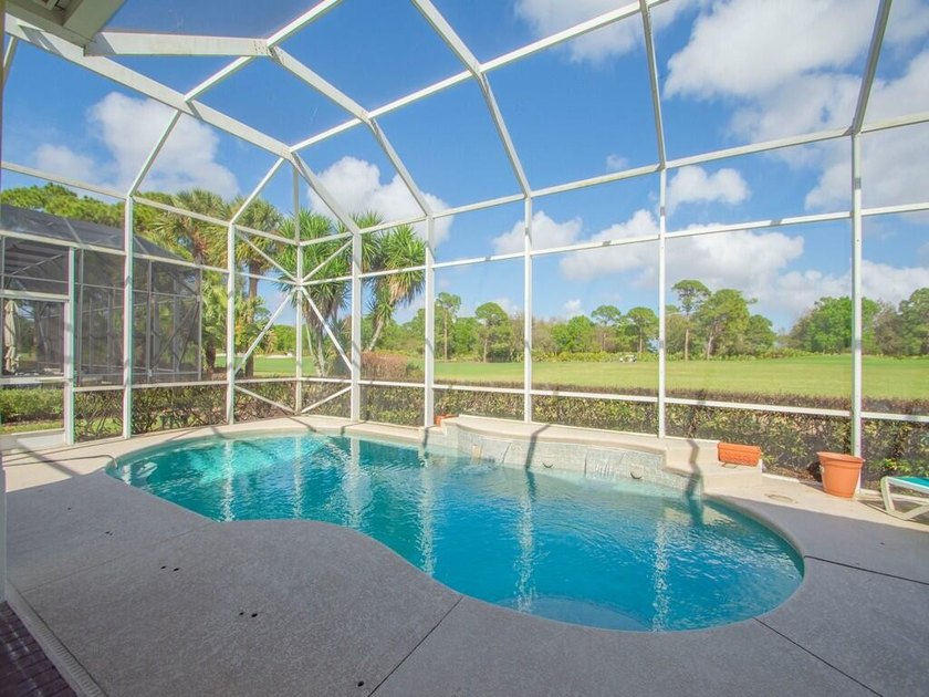 This pool home features a 2022 roof, laminate flooring - photo 19