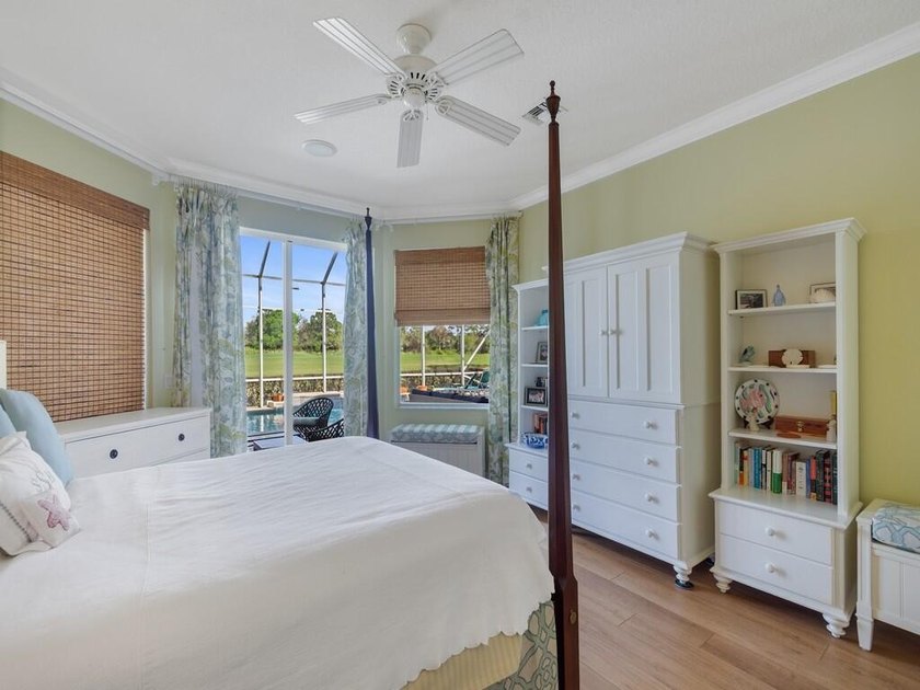 This pool home features a 2022 roof, laminate flooring - photo 26