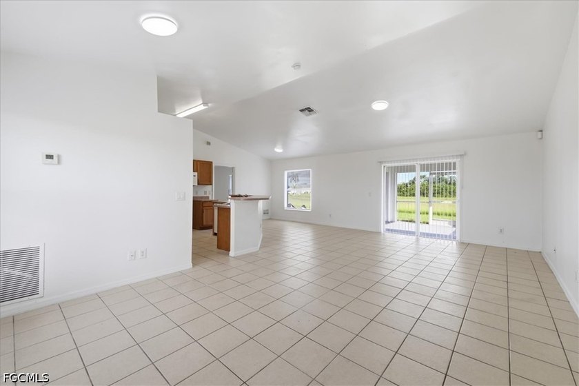 3-bedroom, 2-bath home offering an open-concept layout with tile - photo 12
