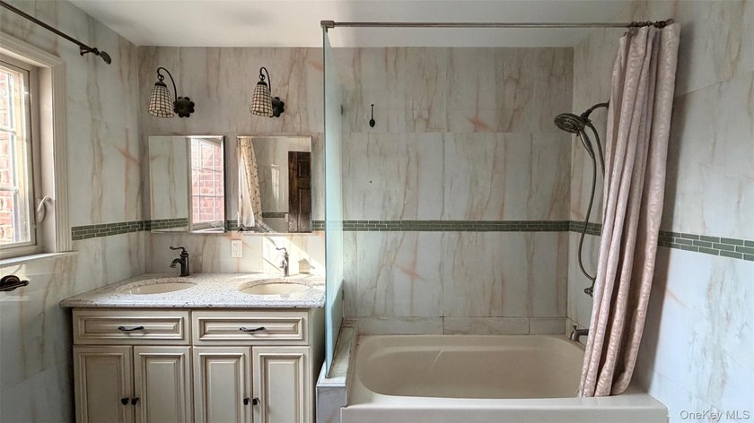 This charming one-family home offers three bedrooms, two and a - photo 12