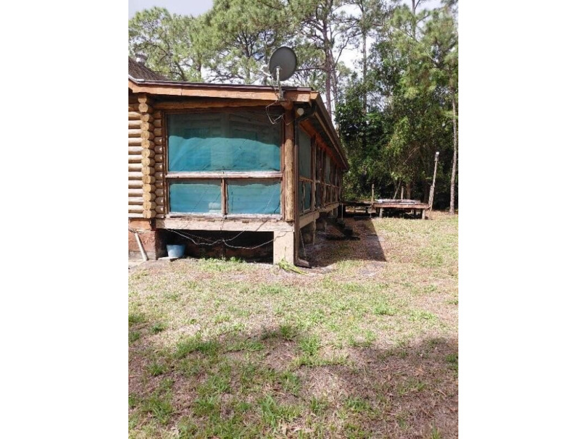 This 2-bedroom, 2-bathroom log cabin offers rustic charm. It is - photo 12