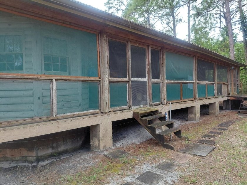 This 2-bedroom, 2-bathroom log cabin offers rustic charm. It is - photo 13
