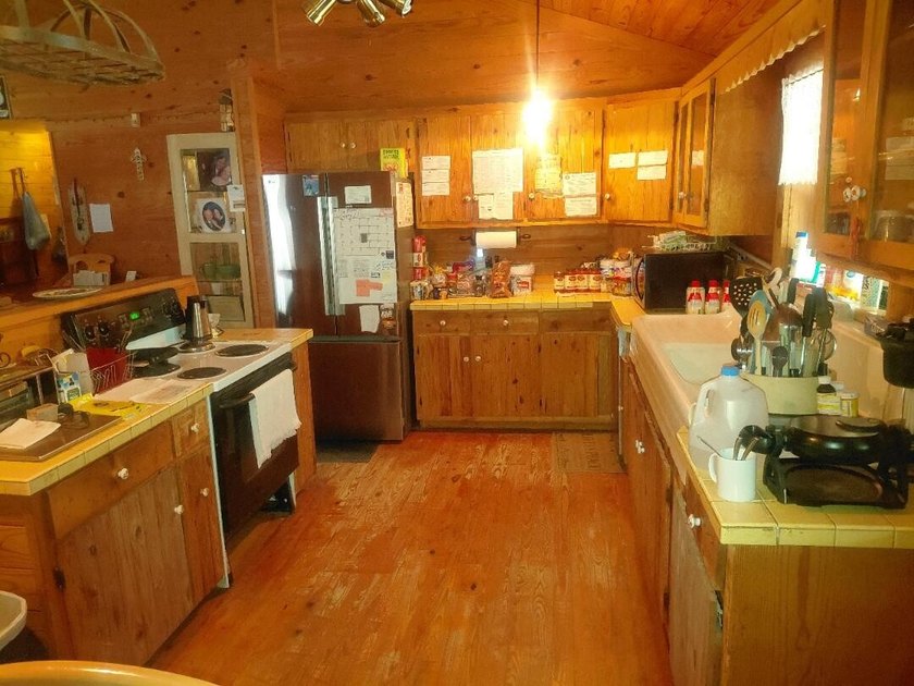 This 2-bedroom, 2-bathroom log cabin offers rustic charm. It is - photo 19