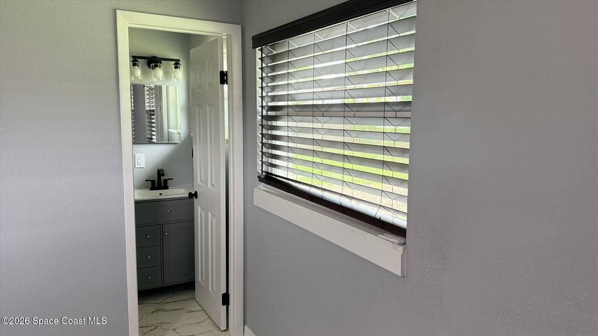 Beautifully remodeled concrete block 4/2 home with a new metal - photo 11
