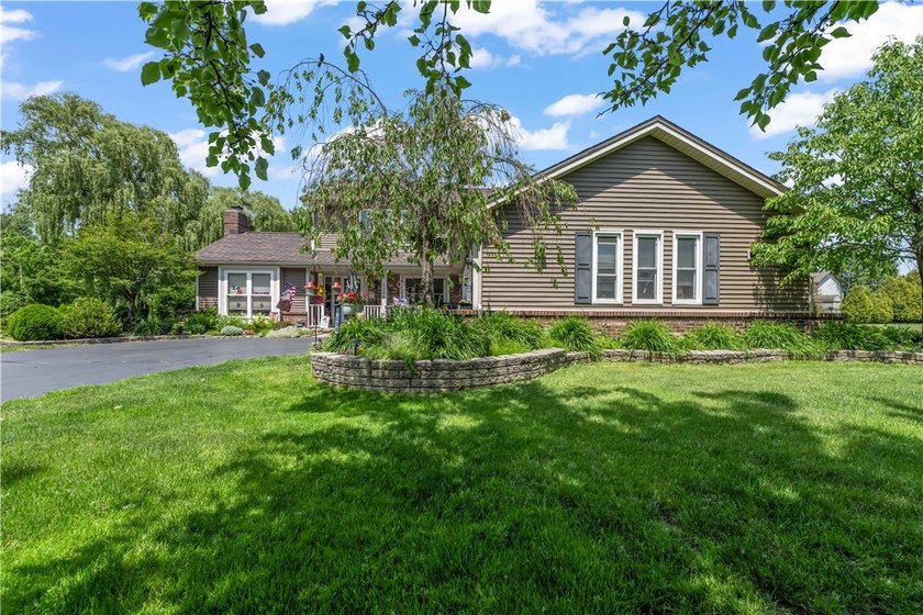 Nestled on a 1.34-acre lot in Webster, this spacious 5-bedroom - photo 2