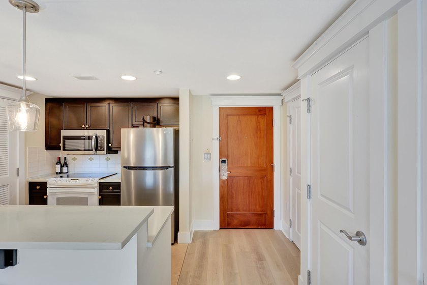 From this third floor covered balcony, enjoy beautiful views of - photo 3