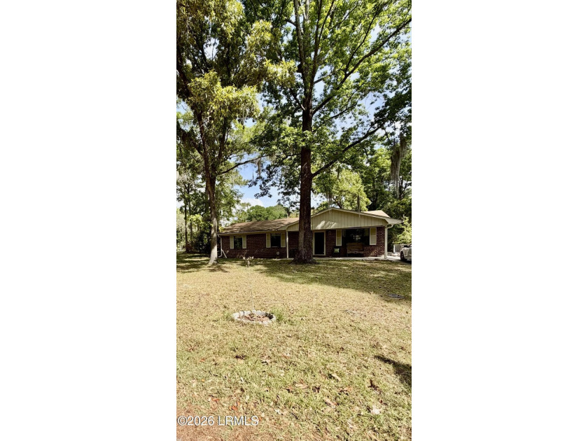 Charming 3-bedroom, 1.5-bath brick home situated on nearly half - photo 3