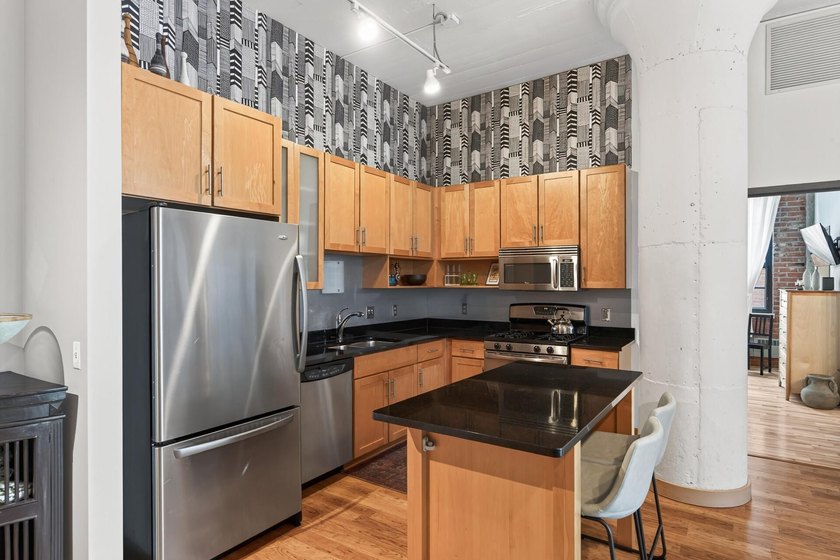 Rare 5th-floor corner loft at American Trio Lofts, filled with - photo 10