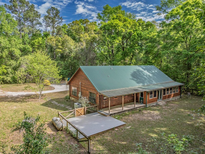 Nestled on over 17 acres this charming log home offers the - photo 5