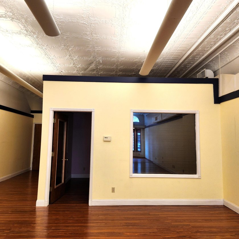 This beautiful downtown building still has original brick work - photo 21