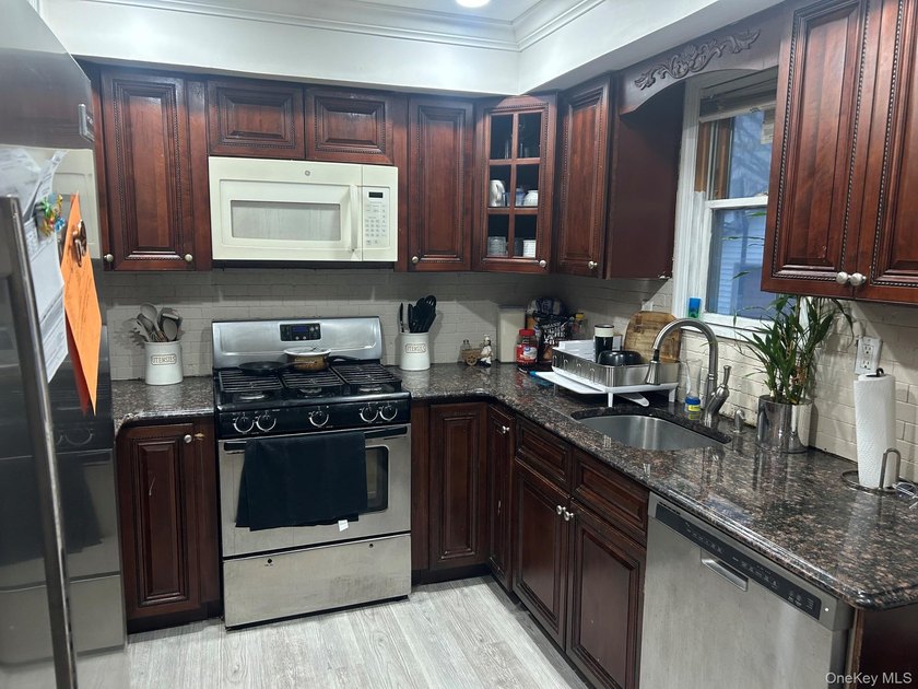 The home features a large driveway, a two-car garage, stainless - photo 6