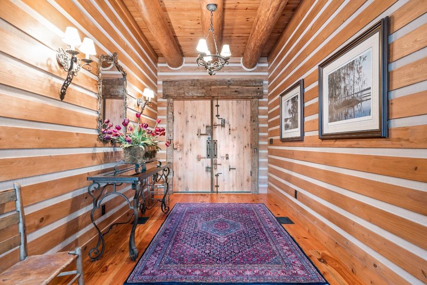 This riverfront property features an expansive, custom log home - photo 11