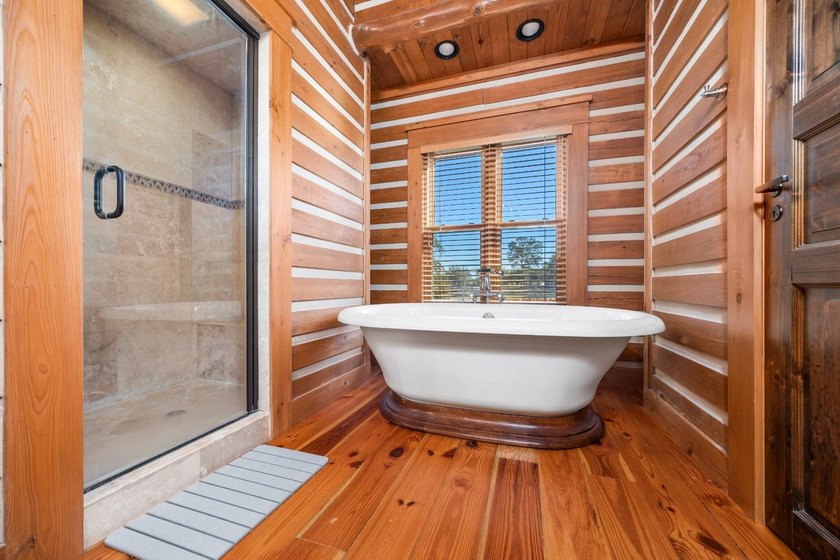 This riverfront property features an expansive, custom log home - photo 16