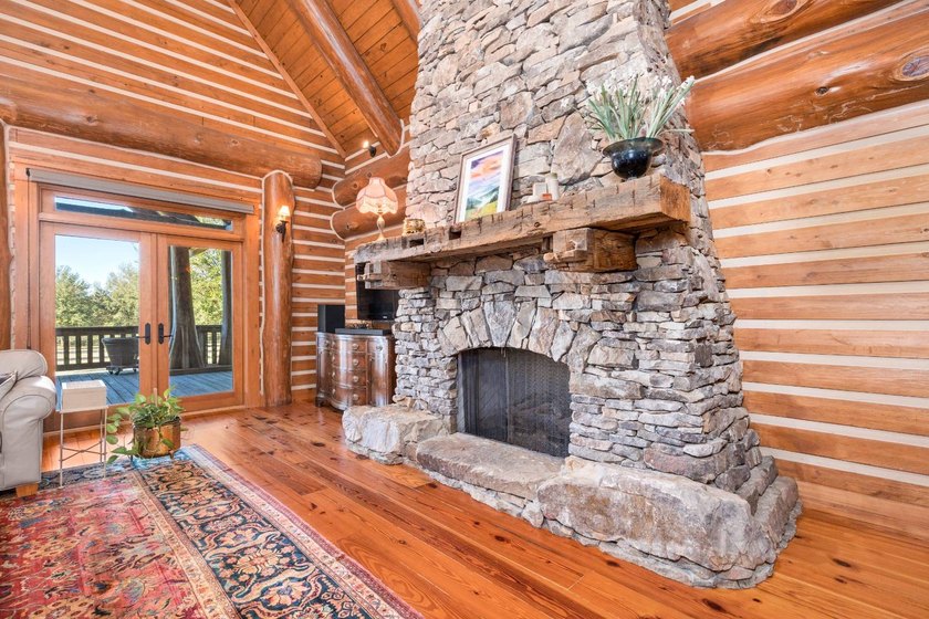 This riverfront property features an expansive, custom log home - photo 17