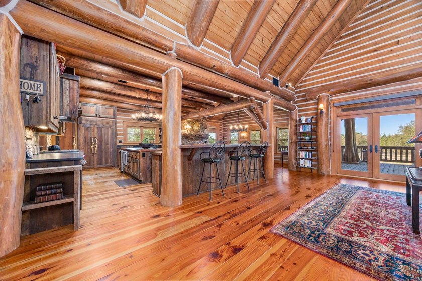 This riverfront property features an expansive, custom log home - photo 20