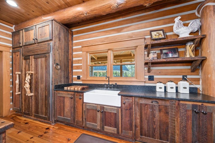 This riverfront property features an expansive, custom log home - photo 22