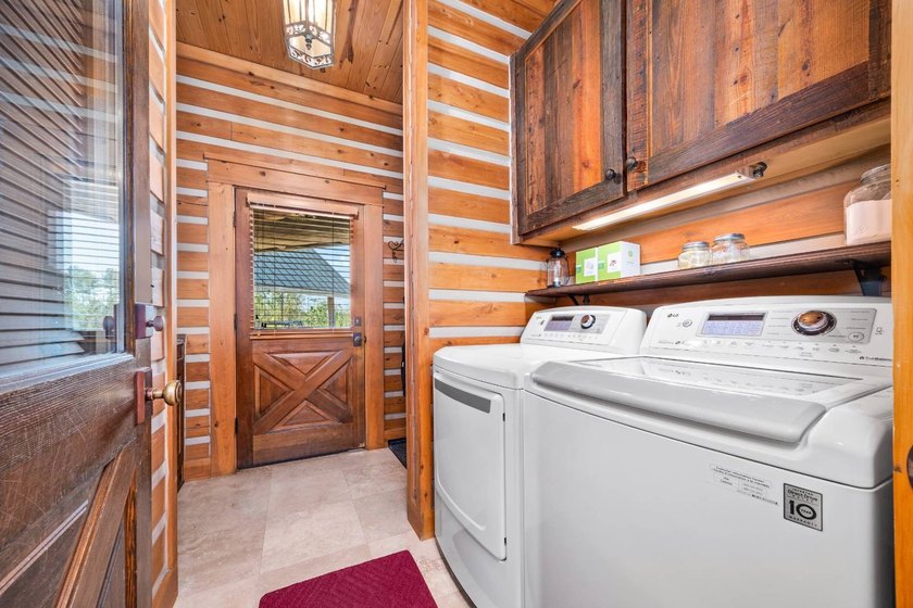 This riverfront property features an expansive, custom log home - photo 24