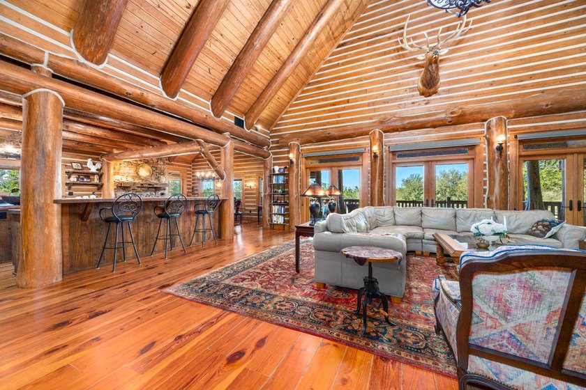 This riverfront property features an expansive, custom log home - photo 26