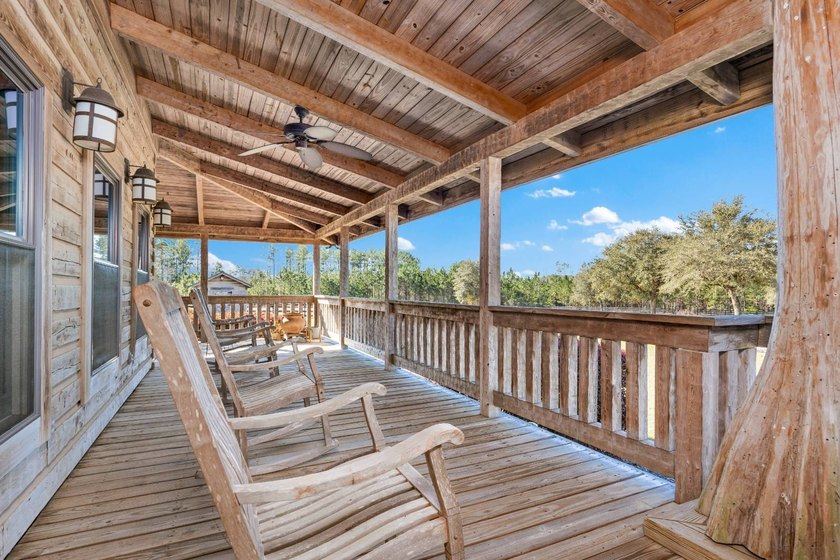 This riverfront property features an expansive, custom log home - photo 28