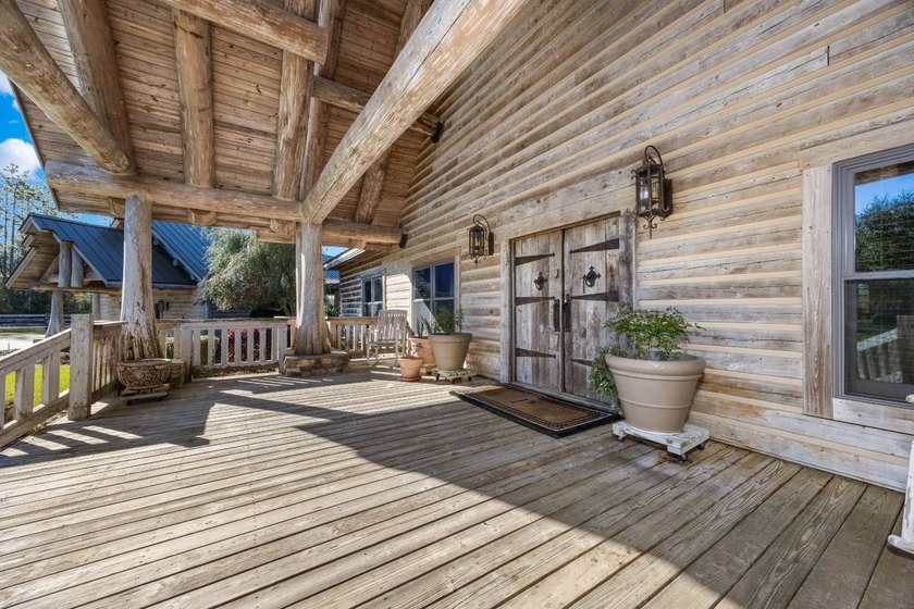 This riverfront property features an expansive, custom log home - photo 29