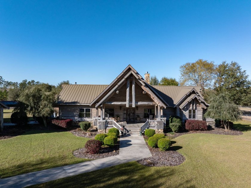 This riverfront property features an expansive, custom log home - photo 31