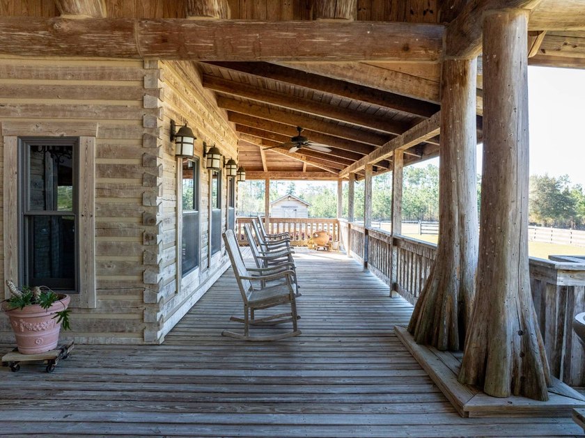 This riverfront property features an expansive, custom log home - photo 33